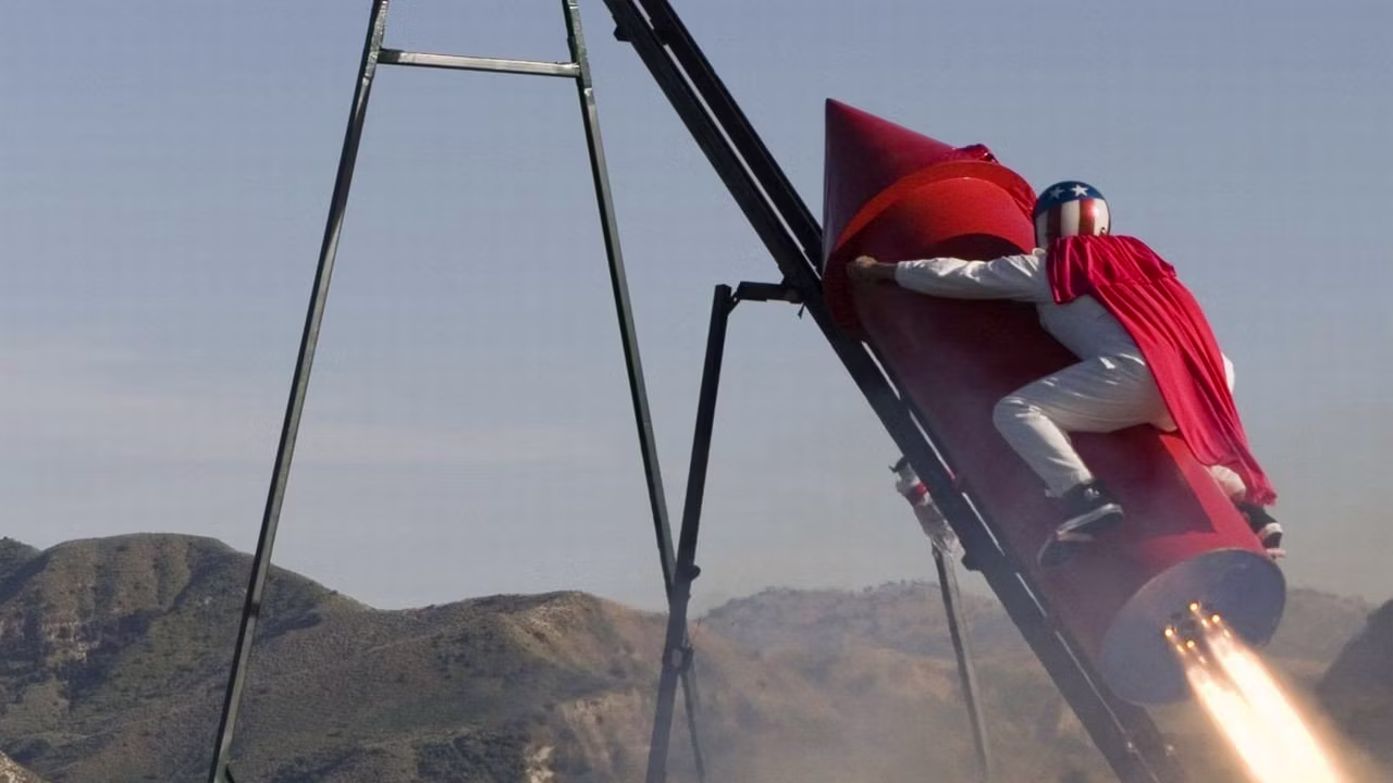 Johnny Knoxville flies his red rocket to the moon.