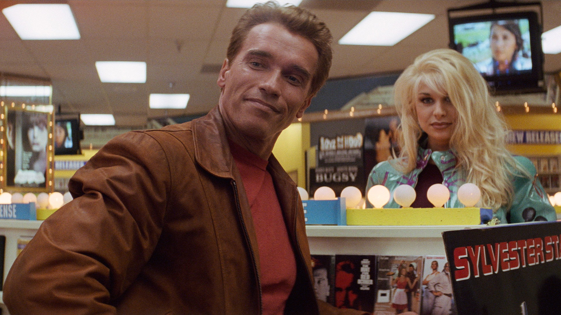 Arnold Schwarzenegger casually hits on a video vixen while arguing with his child co-star in Last Action Hero.