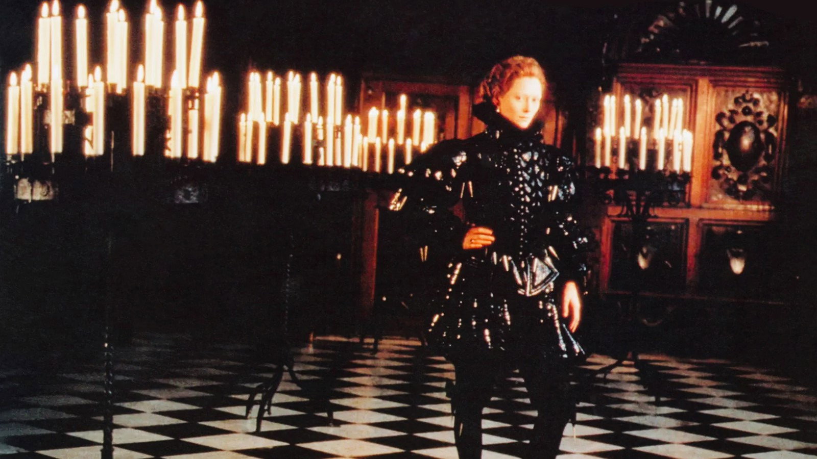 Orlando (Tilda Swinton) stands in front of a truly astonishing number of candles.