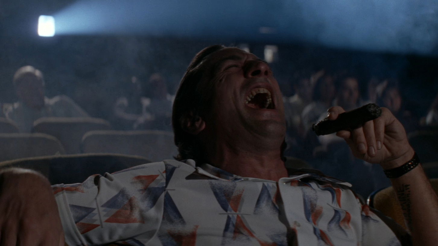 Robert De Niro's Max Cady yuks it up while smoking a cigar at the movies in Cape Fear