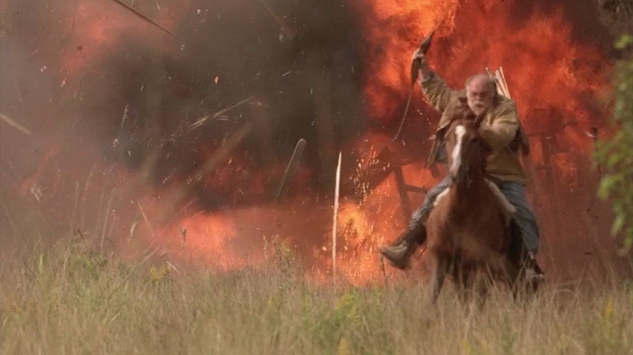 Wilford Brimley rides away from an exploding barn on horseback, shotgun hoisted triumphantly in the air.