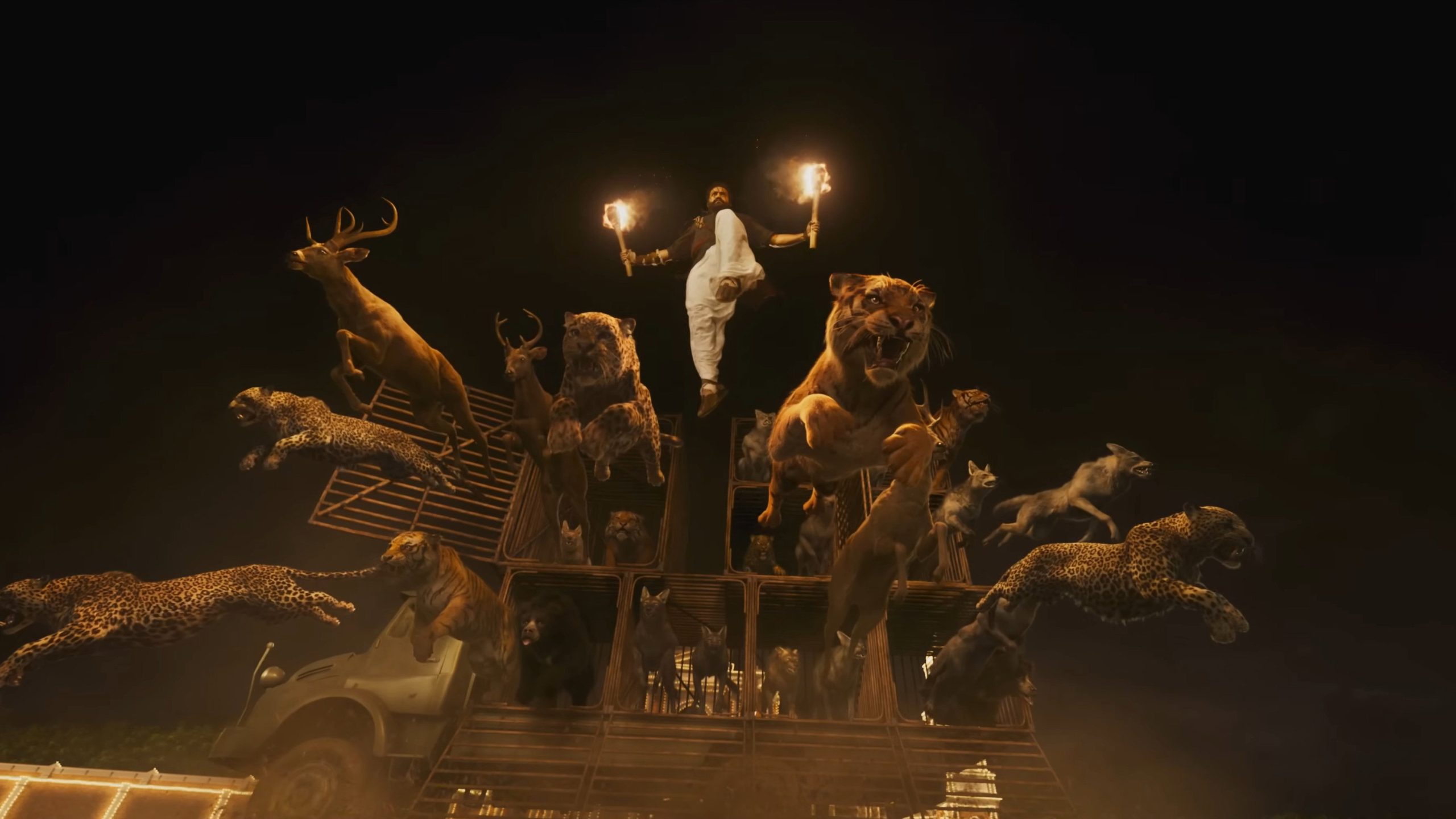Bheem leaps down from a military truck, torches in hand, to join his semi-tamed animals in battle against the British army.